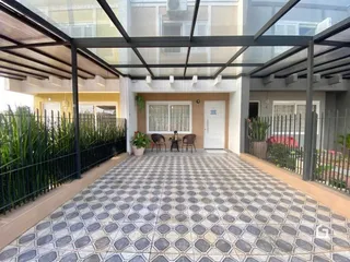 Vista externa de um pátio pavimentado com piso de cerâmica.