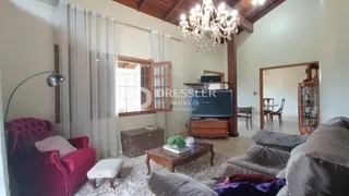 Foto de uma sala de estar com decoração de madeira e cortinas claras.