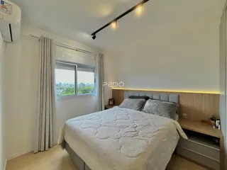 Quarto com cama e janela em um apartamento.