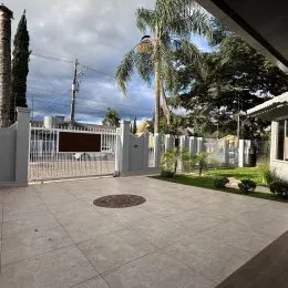 Vista de uma área externa pavimentada com vegetação em uma propriedade em Lajeado.