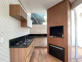 Vista da cozinha com armários de madeira e parede de tijolos na Lajeado.