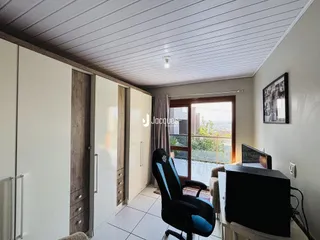 Ambiente interno com portas de correr e vista para o exterior.