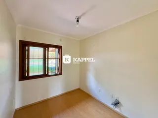 Foto de um cômodo interno com piso de madeira e janela.