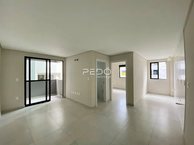 Ambiente interno de uma sala com piso de cerâmica e paredes claras.