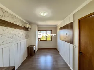 Esta é uma sala longa com painéis de madeira e piso de madeira.