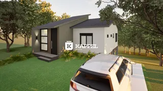 Fachada de uma casa moderna em Lajeado, Brasil, com jardim verde.