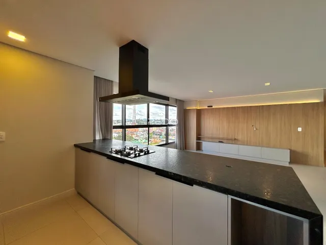 Vista da cozinha moderna com bancada escura e janela ampla em Lajeado.