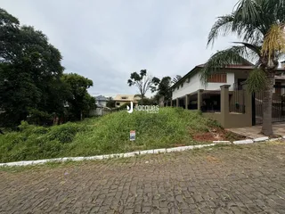 Vista da fachada de uma residência com vegetação densa no primeiro plano.