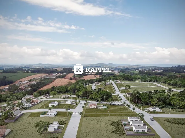 Vista aérea de um loteamento residencial em Lajeado, mostrando casas e áreas verdes.