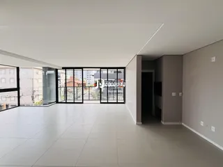 Ambiente interno com piso claro e portas de vidro grandes.