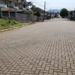 Vista de uma rua pavimentada em uma área residencial.