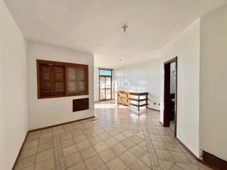 Uma sala de estar com piso de cerâmica e moldura de madeira.