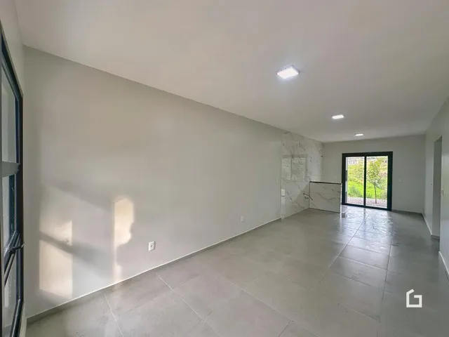 Vista interna de um corredor com piso de cerâmica em uma residência.