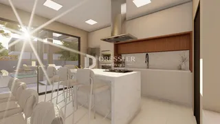 Vista de uma cozinha moderna com ilha e acesso a área externa.