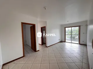 Uma sala ampla com piso de cerâmica e portas de madeira.