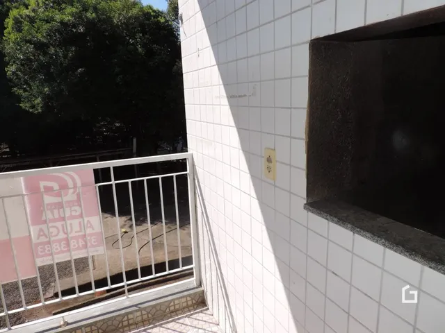 Parede branca com revestimento cerâmico e uma abertura escura em uma propriedade.