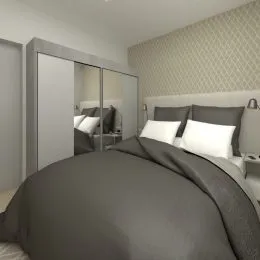 Foto de uma cama com roupa de cama em um quarto.