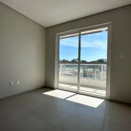 Sala de estar com grande janela que oferece vista externa.