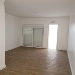 Foto de um ambiente interno com piso de madeira clara.