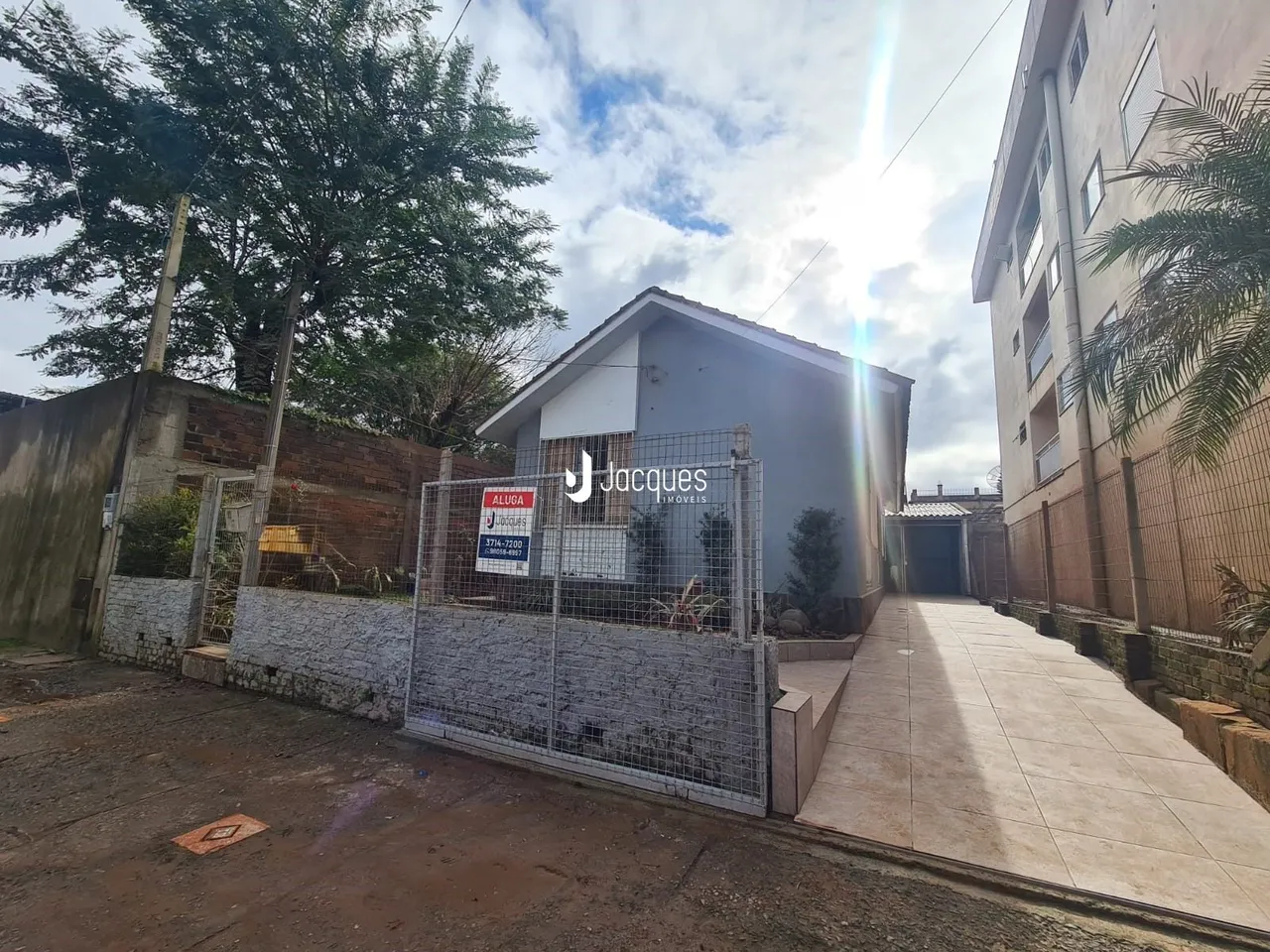 Fachada de uma residência em Lajeado, Brasil, com cerca e acesso ao quintal.