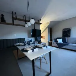 Foto de uma sala de jantar com mesa e vigas expostas no interior do imóvel.