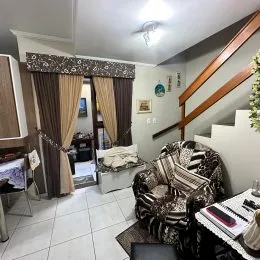 Sala de estar com piso de cerâmica e cortinas escuras.