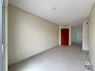 Vista de um corredor interno com paredes brancas e piso de cerâmica clara.