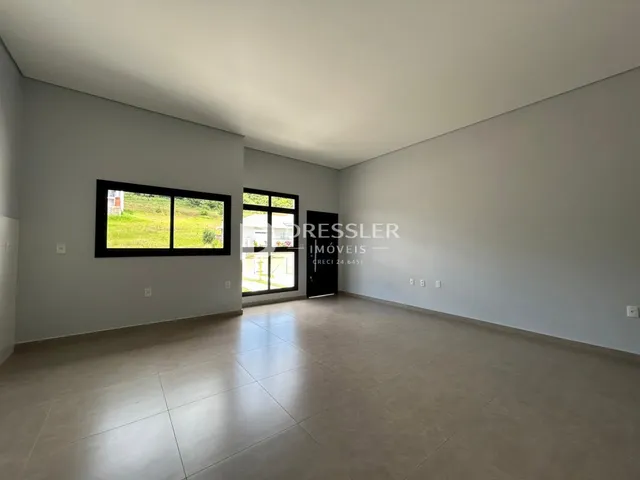 Uma sala com grandes janelas que oferecem vista para o exterior.