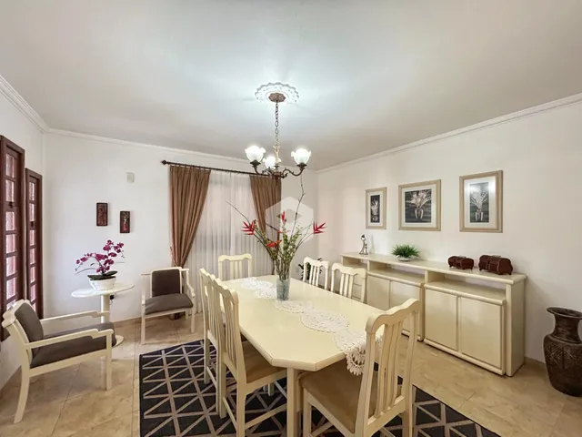 Sala de jantar com mesa e cadeiras em ambiente claro.