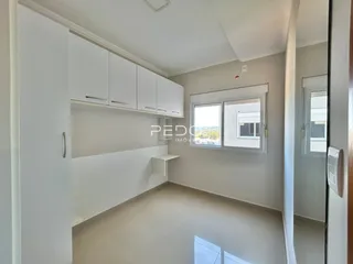 Foto de um cômodo interno com paredes brancas e armários brancos.