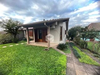 Fachada de uma casa em Lajeado, Brasil com jardim gramado e calçada.