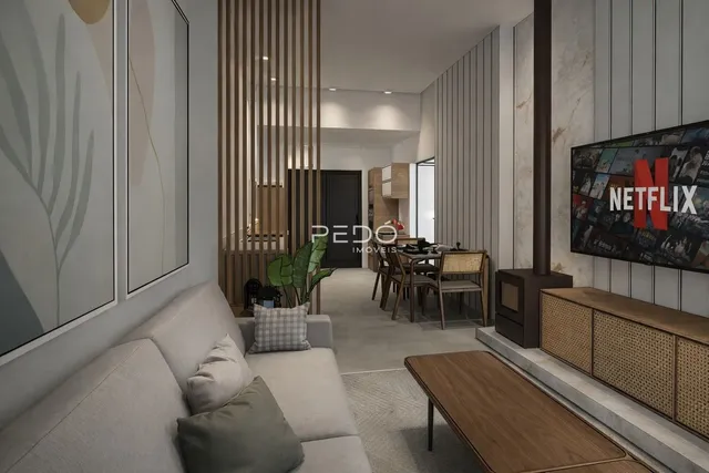 Sala de estar moderna com sofá e decoração em tons neutros.