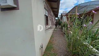 Vista lateral da fachada de uma residência em Lajeado, Brasil, com jardim lateral.