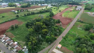 Vista aérea de uma propriedade rural com áreas de mata e campos agrícolas.