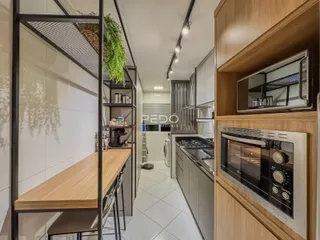 Vista de um ambiente interno moderno com cozinha e área de passagem.