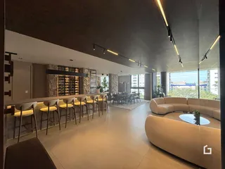 Sala de estar ampla com iluminação moderna e vista para o exterior.