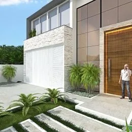 Fachada de uma residência com porta de garagem branca e revestimento de pedra.