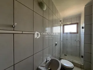 Foto de um banheiro interno com revestimento de cerâmica branca.