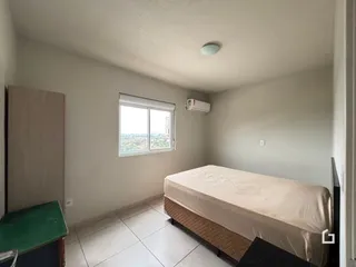 Quarto com janela e cama em apartamento.
