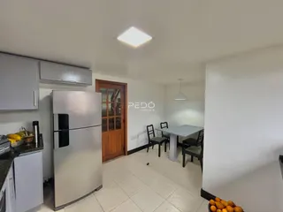 Uma área de jantar com cozinha é visível no interior da propriedade.