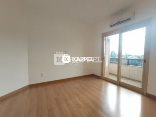 Sala de estar com piso de madeira e porta de vidro que dá para a vista.