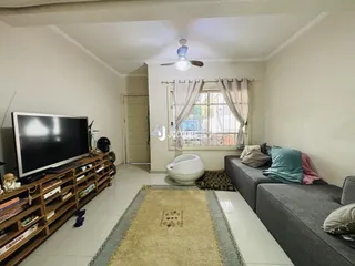 Sala de estar com sofá e banheira em um imóvel no Brasil.