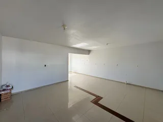 Ambiente interno de uma área com piso de cerâmica clara e paredes brancas.