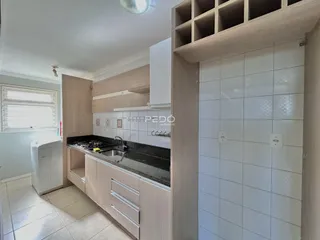 Cozinha com armários e bancada escura.