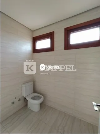 Banheiro com piso de cerâmica e paredes claras.