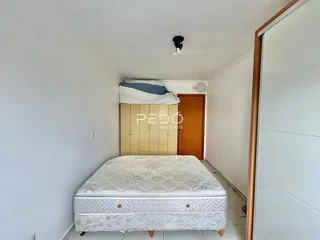 A foto mostra um quarto com cama e armário em uma residência.