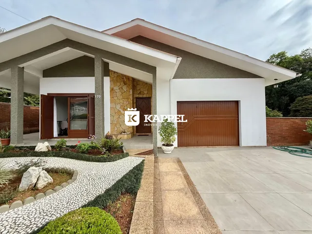 Foto da fachada de uma casa residencial em Lajeado, Brasil, mostrando a entrada e o jardim frontal.