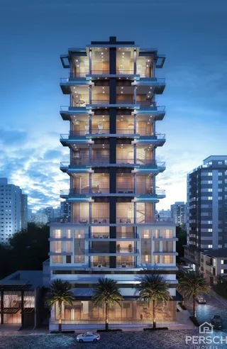 Fachada de um prédio residencial moderno em Lajeado, Brasil, ao anoitecer.
