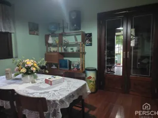 Mesa de jantar coberta com toalha de renda em um ambiente interno.