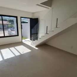Ambiente interno com piso claro e iluminação natural em uma sala.